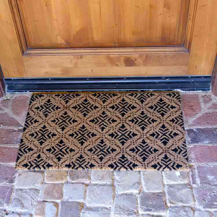Classic Fleur de Lis French Matting Close Up on Brick Entrance