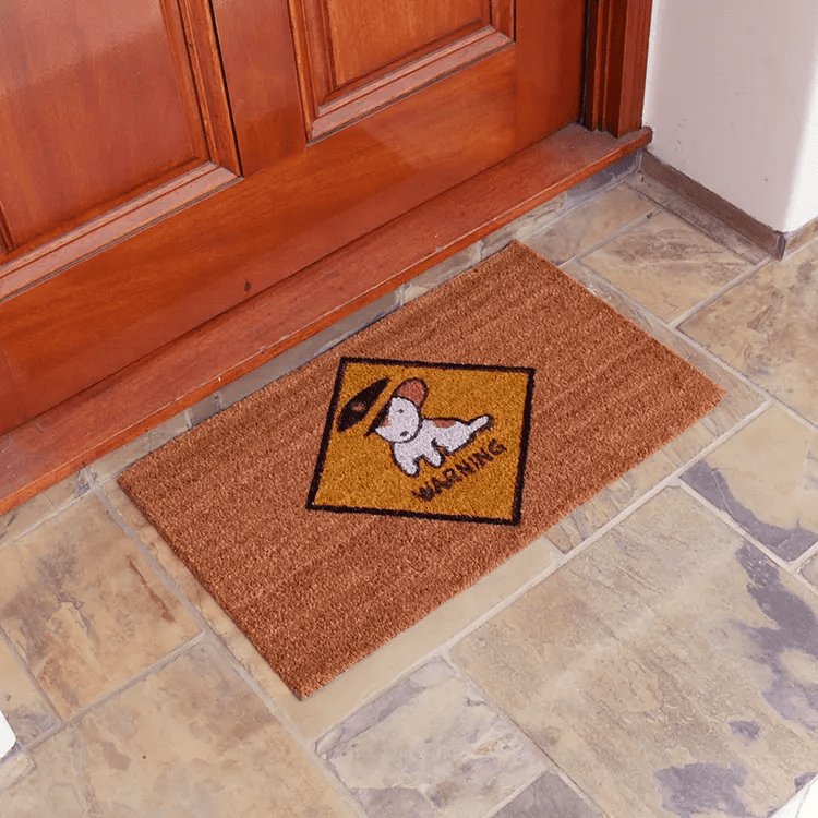 Brown Doormat with Warning Dog Sign is Placed in Front of a Brown Door