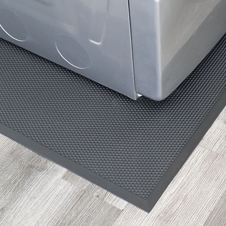 Edge of the Rubber Washer and Dryer Mat Pointing Down