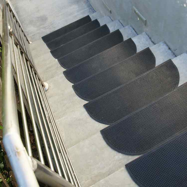 Black Rubber Grip-Tight" Dotted Stair Treads with Rounded Corners Leading Down Concrete Steps