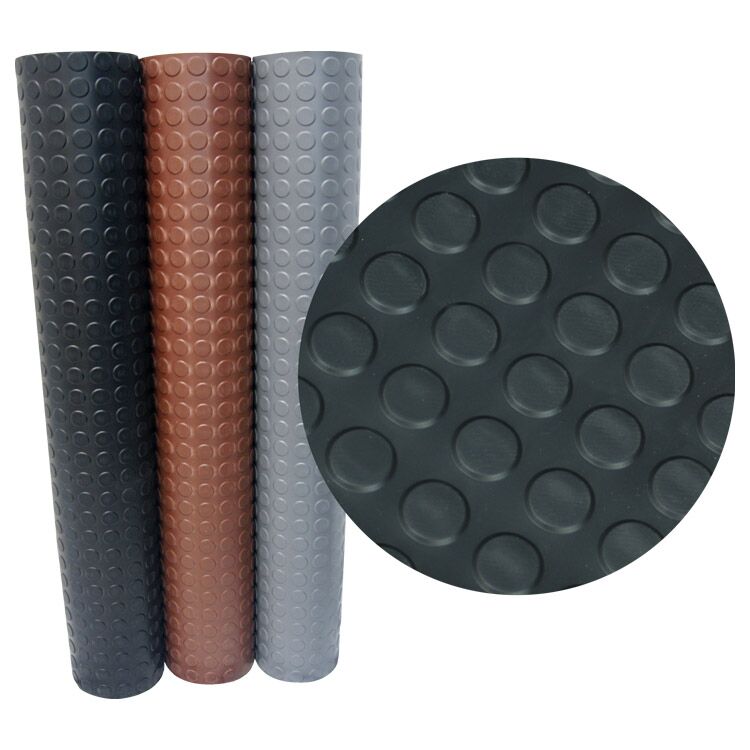 Three Vertically Standing Rubber Coin-Top Rubber Flooring Rolls with a Close Up Textured View Three Vertically Standing Rubber Coin-Top Rubber Flooring Rolls with a Close Up Textured View