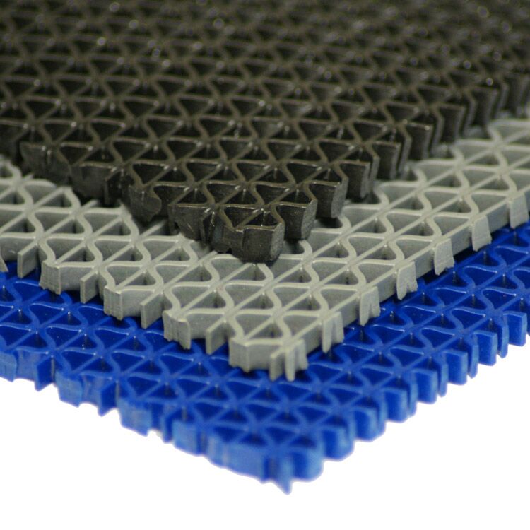 Corner Shot of Three Layers of S-Grip PVC Drainage Mats, with Black on Top, Grey in the Middle, and Blue on the Bottom Corner Shot of Three Layers of S-Grip PVC Drainage Mats, with Black on Top, Grey in the Middle, and Blue on the Bottom