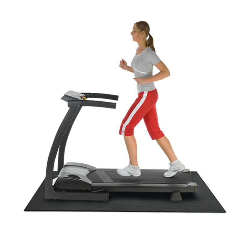 Woman Using Treadmill That is on Top of Black Recycled Rubber Mat Woman Using Treadmill That is on Top of Black Recycled Rubber Mat