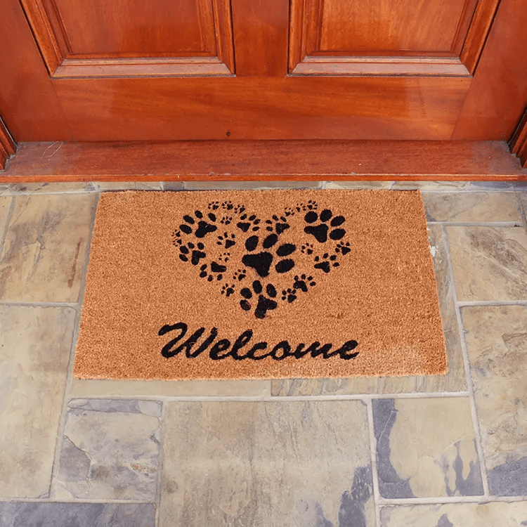 Front View of a Brown Doormat with Paw Prints Forming a Heart in Front of Brown Door